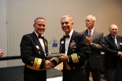 CAPT Juim Donovan, USN (Ret) accepts CAPT Kelly Award on behalf of Mr. George Miller from VADM Connor